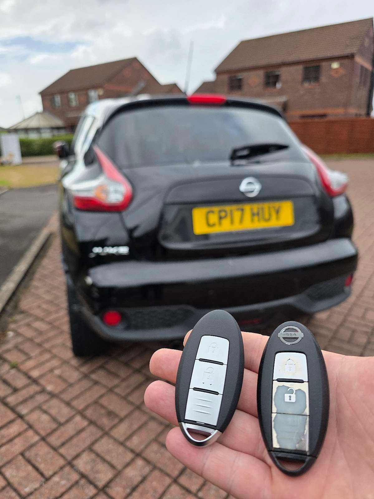 Nissan smart key replacement in Swansea – locksmith holding two new keys